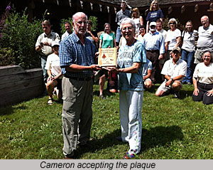 Cameron accepting the plaque