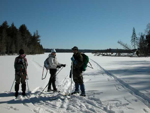trail clearing crew preparing to cross a wilderness lake/Dan Wallace